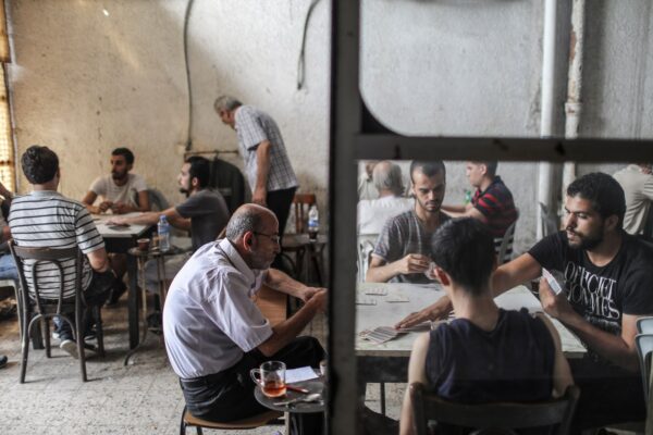 Palestinians play cards inside al-Karawan cafe in Gaza City. (Wissam Nassar/for The Washington Post)